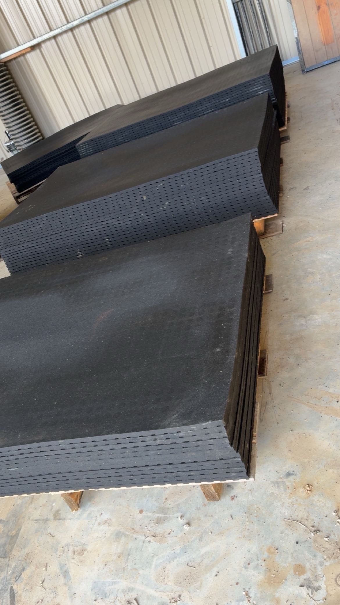 Rubber mats stacked in warehouse
