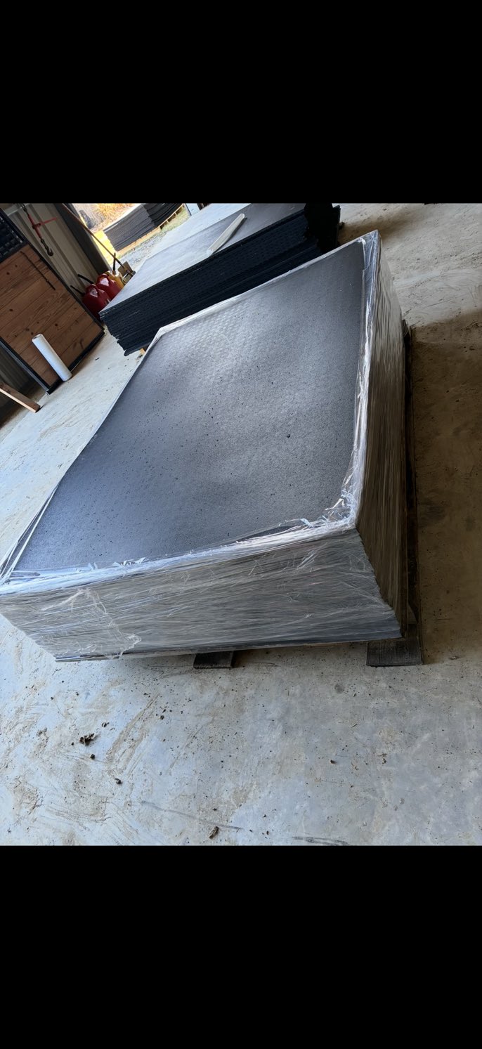 Shrink-wrapped pallet of rubber mats ready for shipping